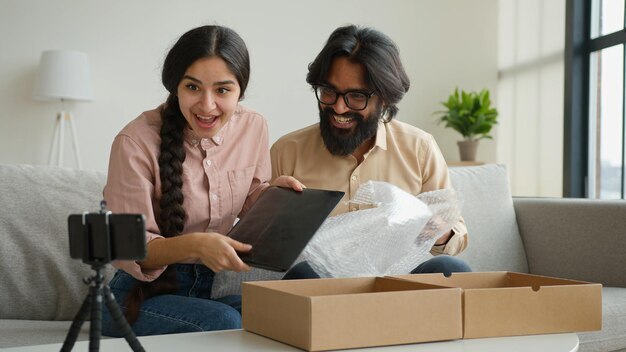couple-bloggers-customers-open-package-box-order-online-shopping-delivery-excited-happy-arabian-man_717737-15978